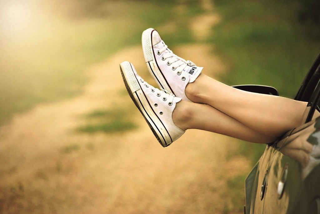 Laser hair removal woman's hairless legs outside a car window