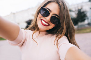 girl taking a selfie in sunglasses